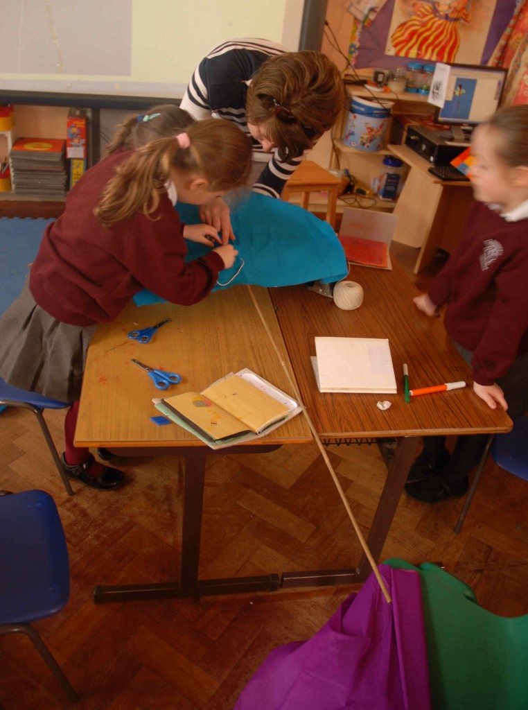 Mrs Carolan and the children at this table are busy making their kite.
