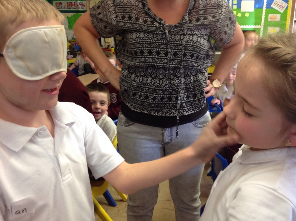 The children explore guessing who it is by relying on their sense of touch!