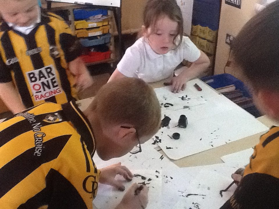 Here the children are finding out what its like to use a FEATHER, A STICK and A REAL INK PEN!